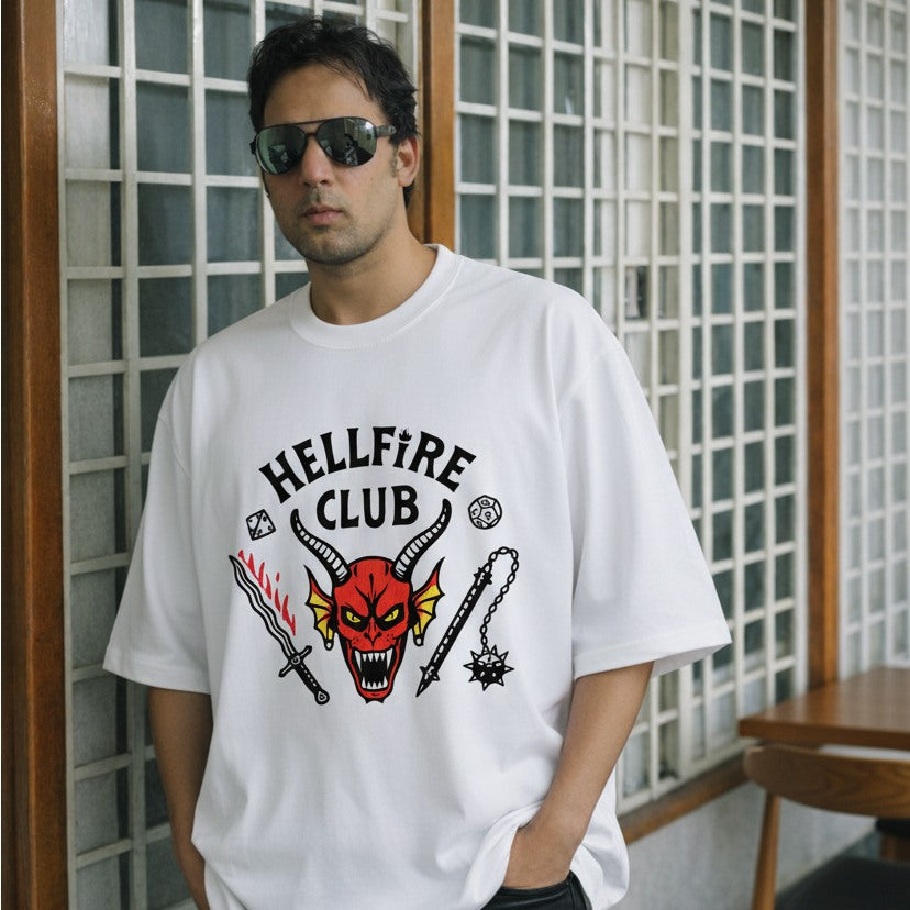 Person wearing a white t-shirt with 'Hellfire Club' graphic design.