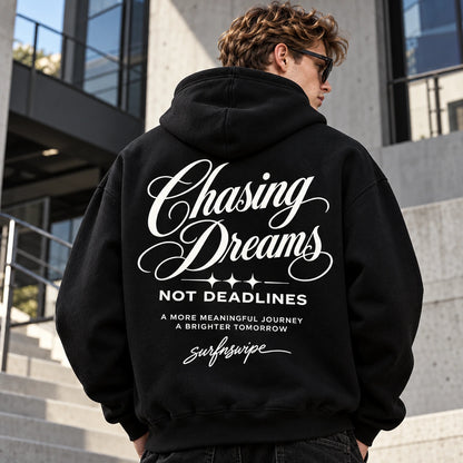 Man wearing a black Chasing Dreams oversized hoodie
