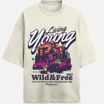 Beige t-shirt with a graphic design featuring a person on a skateboard and text 'Living Young, Wild & Free' on a white background.