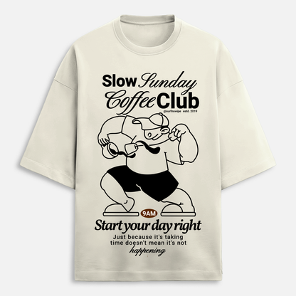 Beige t-shirt with black graphic and text on a white background