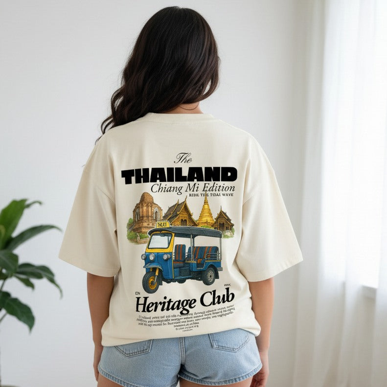 Person wearing a t-shirt with a graphic design on the back, featuring text and an illustration of a tuk-tuk.