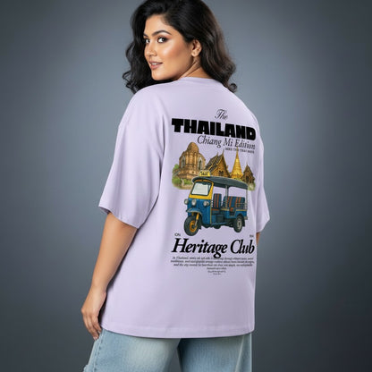 Woman wearing a lavender t-shirt with Thailand-themed graphics and text.