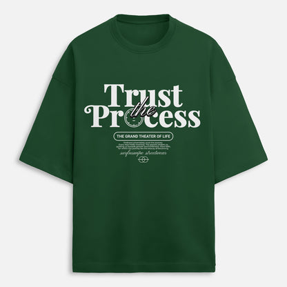 Green t-shirt with 'Trust the Process' text on a white background