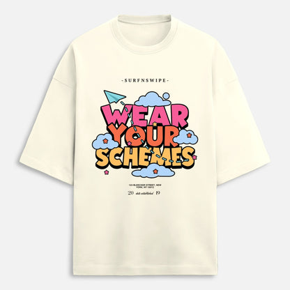 Off-white oversized cotton t-shirt flat lay showing full Wear Your Schemes retro cloud graphic print