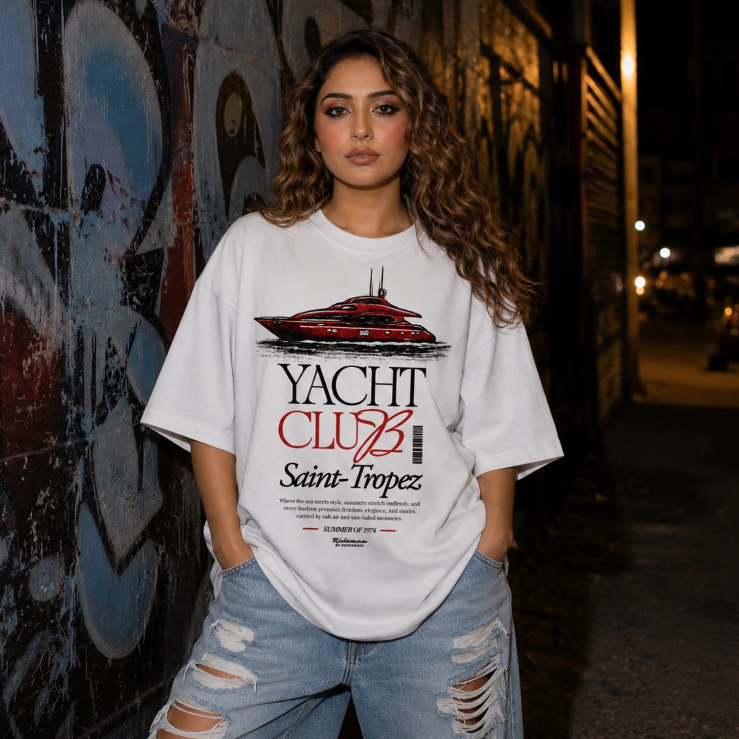 Woman wearing white Yacht Club Saint-Tropez oversized tee with ripped denim jeans