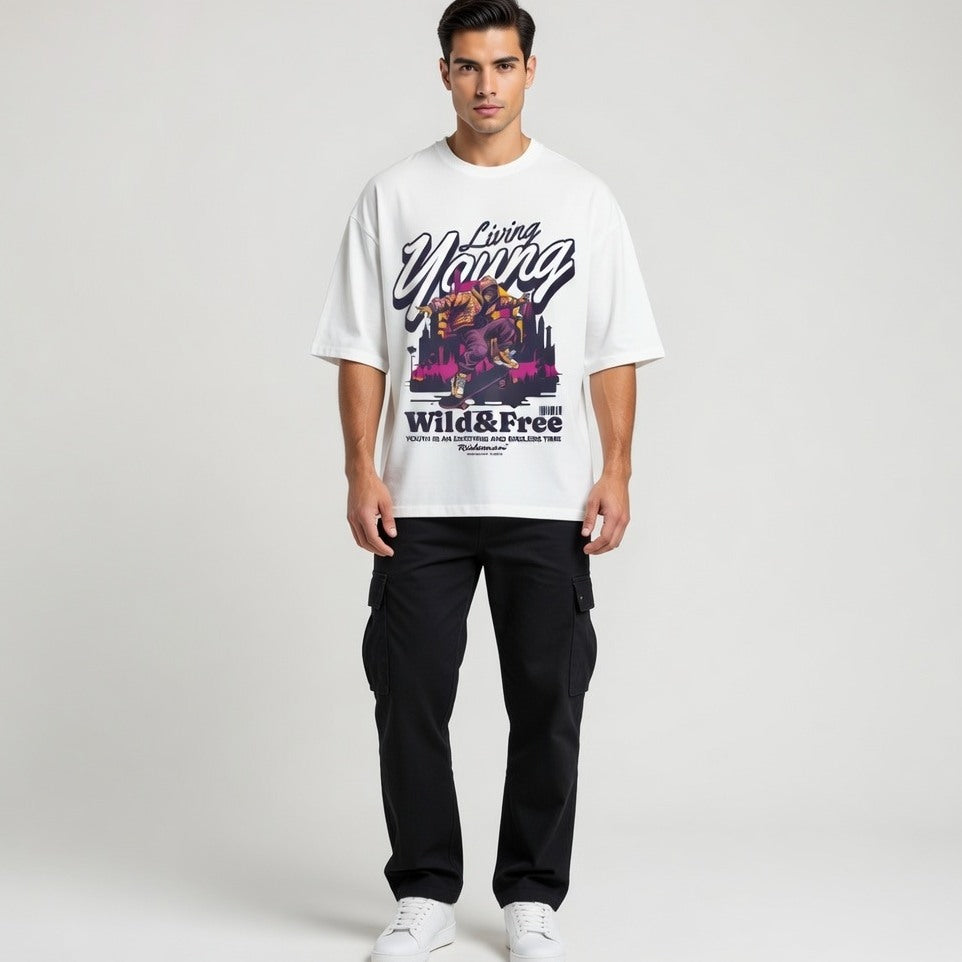 Man wearing a white t-shirt with colorful graphics and text on a plain background