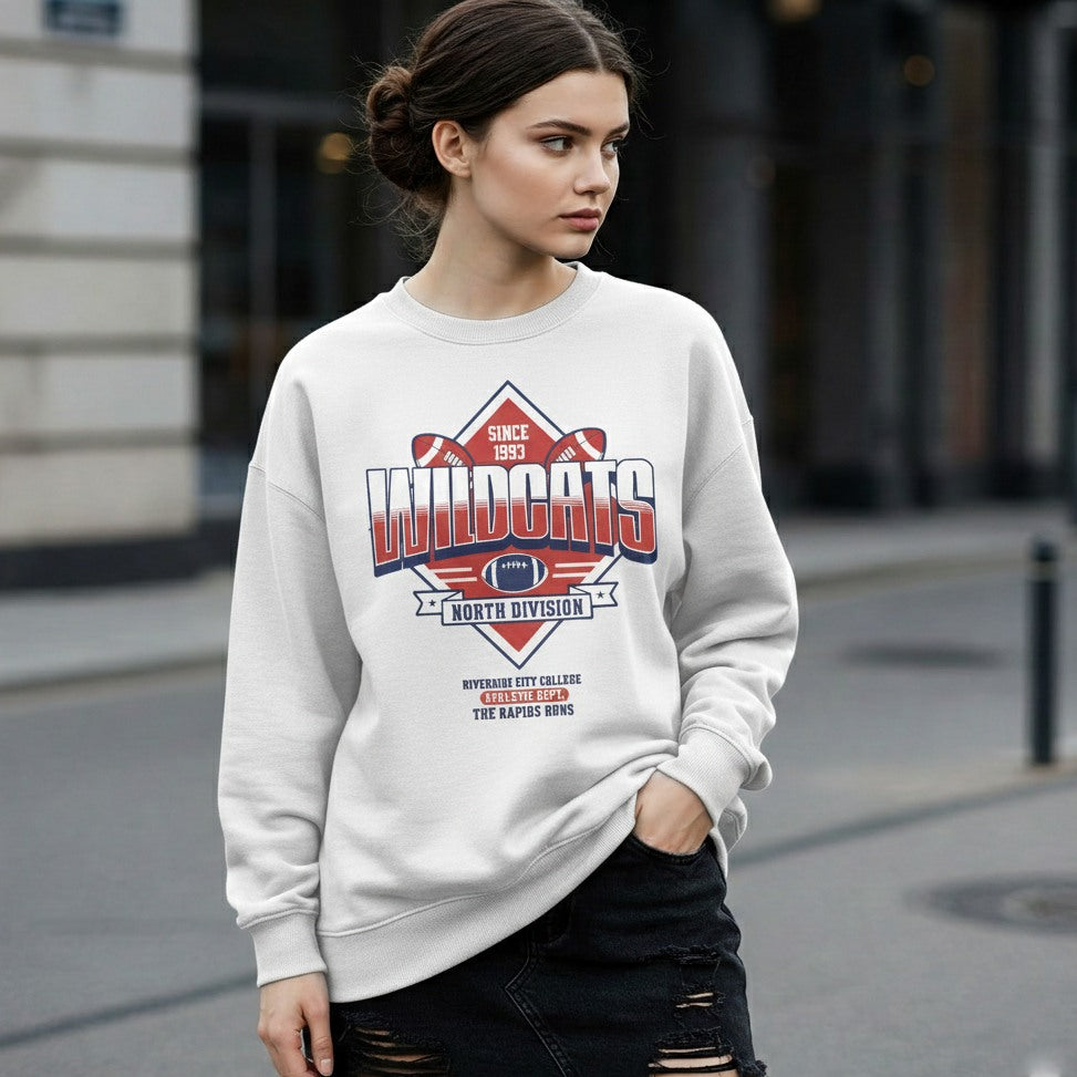 Woman wearing a white sweatshirt with 'Wildcats' design on a city street.