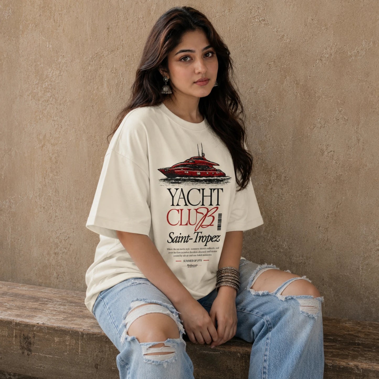 Woman wearing Off-white 
Yacht Club Saint-Tropez oversized tee with ripped denim jeans