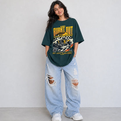 Woman wearing SURFNSWIPE Burnt Out Hot Rod oversized T-shirt in Petrol blue styled with ripped wide-leg jeans